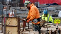 Construction worker wiring rebar