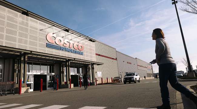 Customer walking toward Costco store Customer walking toward Costco store