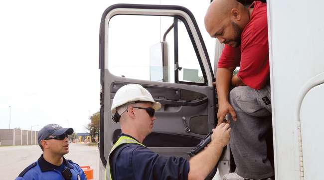 Truck driver getting credentials checked Truck driver getting credentials checked