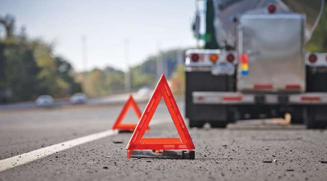 Truck parked with warning triangles behind it Truck parked with warning triangles behind it